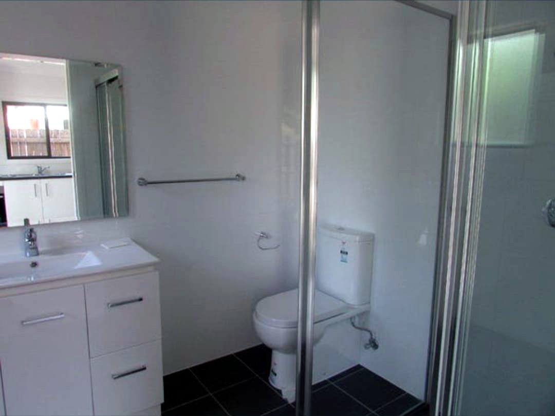 Bathroom in the Doonside home, with a shower, vanity and toilet