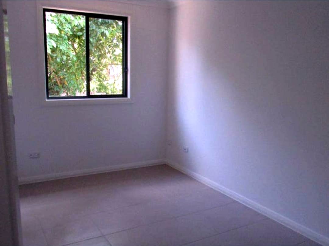 Bedroom in the Doonside home, with a window