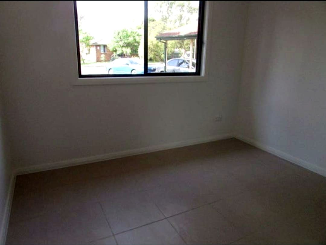 Second bedroom in the Doonside home, with a window to the street